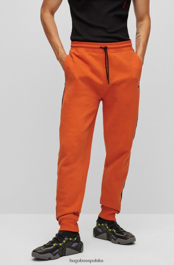 Hugo Boss Ciemnopomarańczowe spodnie dresowe Hugo z bawełny organicznej z taśmą z logo ciemna pomarańcza R0X0H61573