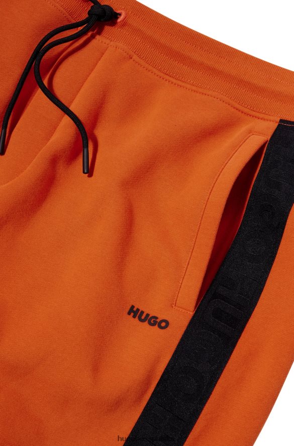 Hugo Boss Ciemnopomarańczowe spodnie dresowe Hugo z bawełny organicznej z taśmą z logo ciemna pomarańcza R0X0H61573
