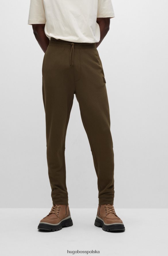 Hugo Boss Ciemnozielone spodnie dresowe hugo z bawełny frotte i naszywką z logo ciemnozielony R0X0H61437