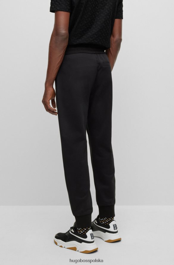 Hugo Boss Czarne spodnie dresowe hugo z bawełny frotte i logo wypełnionym monogramami czarny R0X0H62634