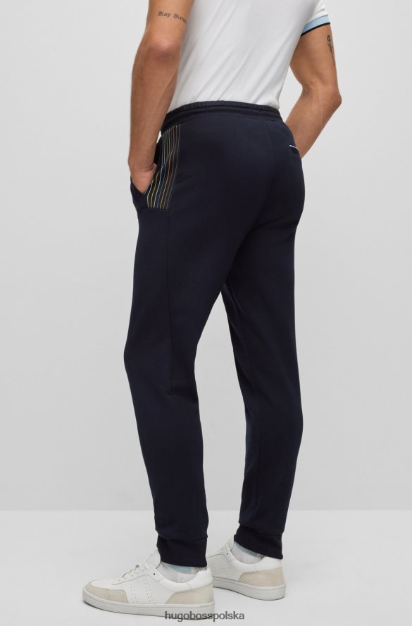 Hugo Boss Hugo ciemnoniebieskie spodnie dresowe z mieszanki bawełny z detalami w wielokolorowe paski ciemny niebieski R0X0H61732