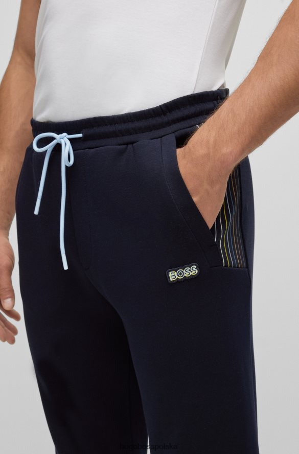 Hugo Boss Hugo ciemnoniebieskie spodnie dresowe z mieszanki bawełny z detalami w wielokolorowe paski ciemny niebieski R0X0H61732