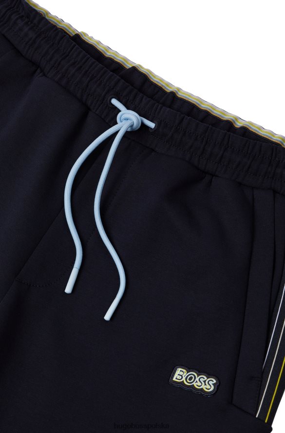 Hugo Boss Hugo ciemnoniebieskie spodnie dresowe z mieszanki bawełny z detalami w wielokolorowe paski ciemny niebieski R0X0H61732