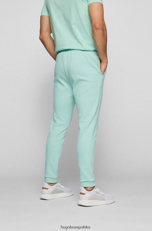 Hugo Boss Jasnozielone, bawełniane spodnie dresowe Hugo z zaokrąglonym logo jasnozielony R0X0H62535