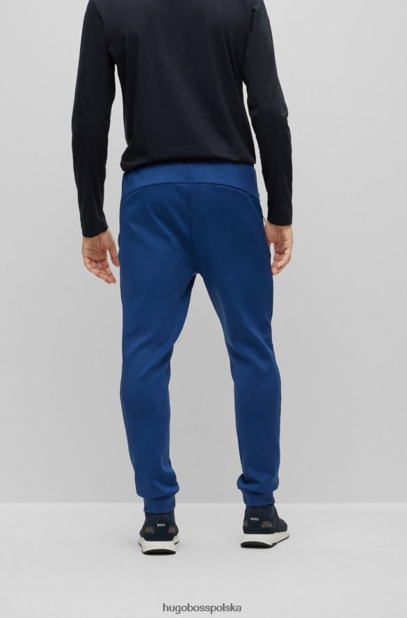 Hugo Boss Spodnie dresowe hugo o regularnym kroju, melanżowe, z ozdobnymi odblaskowymi detalami w kolorze ciemnoniebieskim ciemny niebieski R0X0H63537