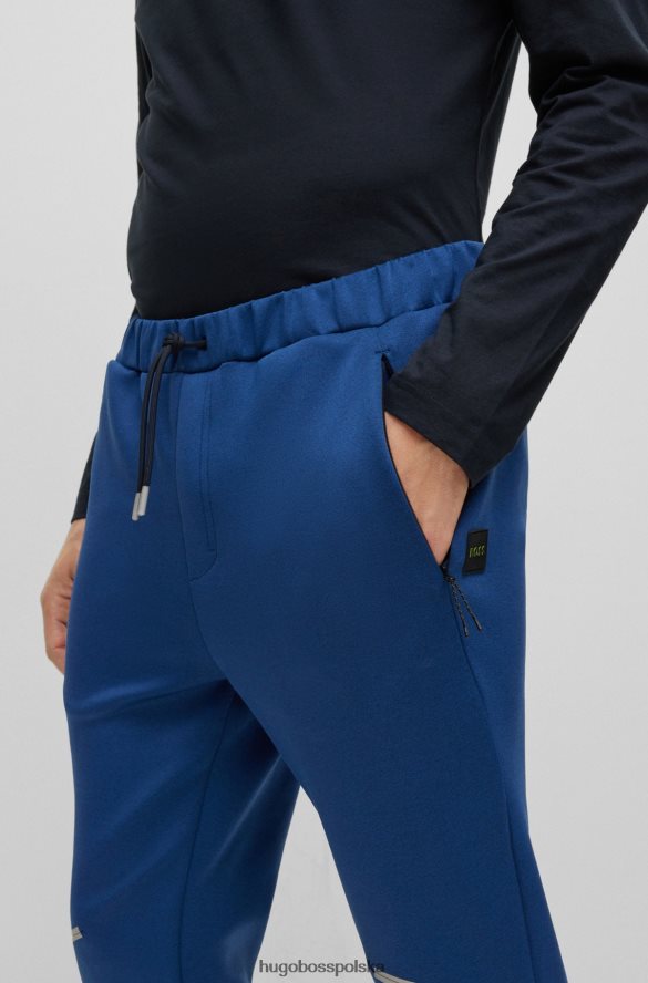 Hugo Boss Spodnie dresowe hugo o regularnym kroju, melanżowe, z ozdobnymi odblaskowymi detalami w kolorze ciemnoniebieskim ciemny niebieski R0X0H63537