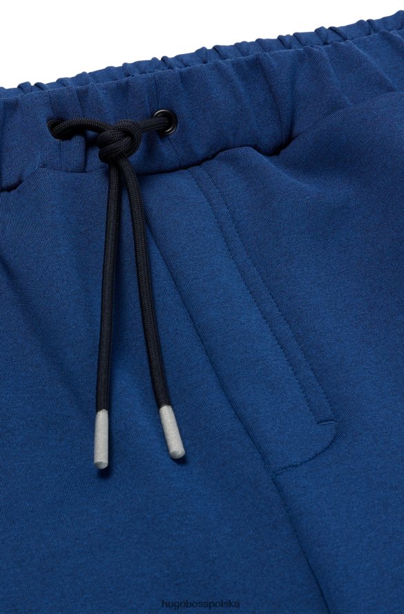 Hugo Boss Spodnie dresowe hugo o regularnym kroju, melanżowe, z ozdobnymi odblaskowymi detalami w kolorze ciemnoniebieskim ciemny niebieski R0X0H63537