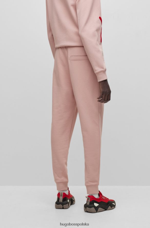 Hugo Boss Spodnie dresowe hugo z bawełny frotte, z odręcznym haftem logo w kolorze jasnoróżowym jasnoróżowy R0X0H63549