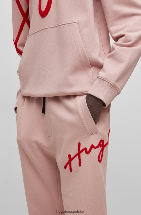 Hugo Boss Spodnie dresowe hugo z bawełny frotte, z odręcznym haftem logo w kolorze jasnoróżowym jasnoróżowy R0X0H63549