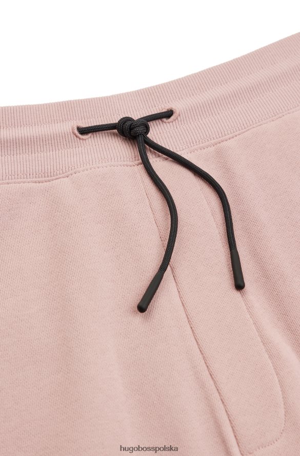 Hugo Boss Spodnie dresowe hugo z bawełny frotte, z odręcznym haftem logo w kolorze jasnoróżowym jasnoróżowy R0X0H63549