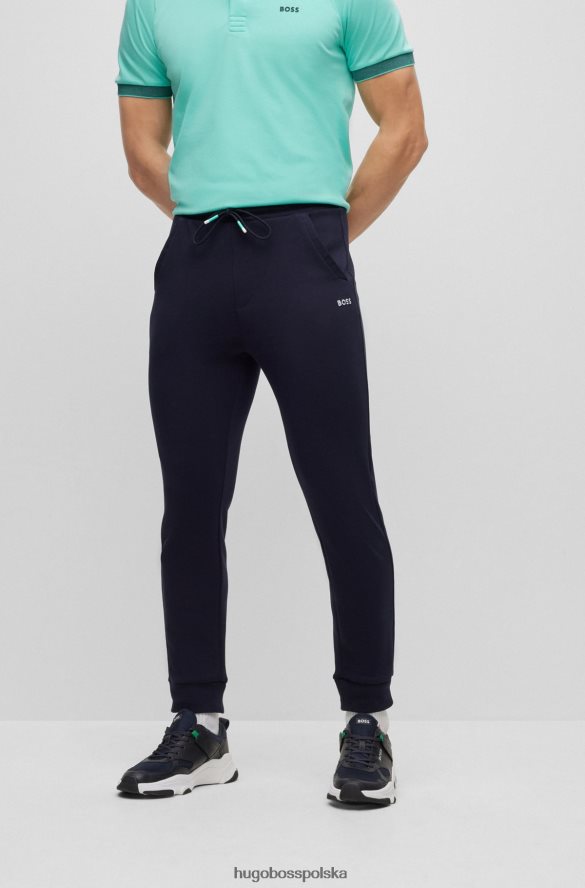Hugo Boss Spodnie dresowe o regularnym kroju z wielobarwnymi logo hugo w kolorze granatowym ciemny niebieski R0X0H63528