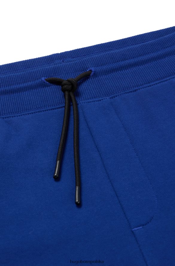 Hugo Boss Spodnie dresowe z bawełny frotte z grafiką z logo Hugo Blue niebieski R0X0H61953