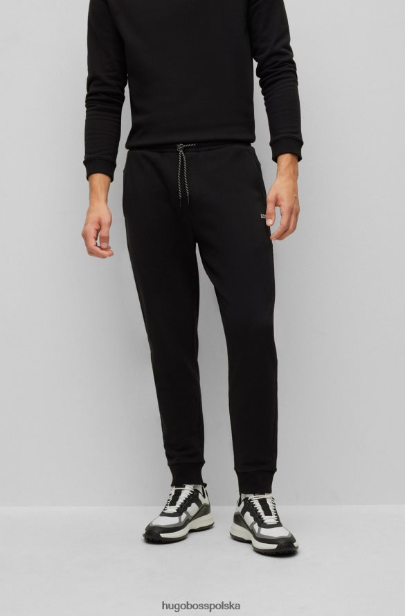 Hugo Boss Spodnie dresowe z bawełny frotte z kontrastowym logo Hugo w kolorze czarnym czarny R0X0H63288