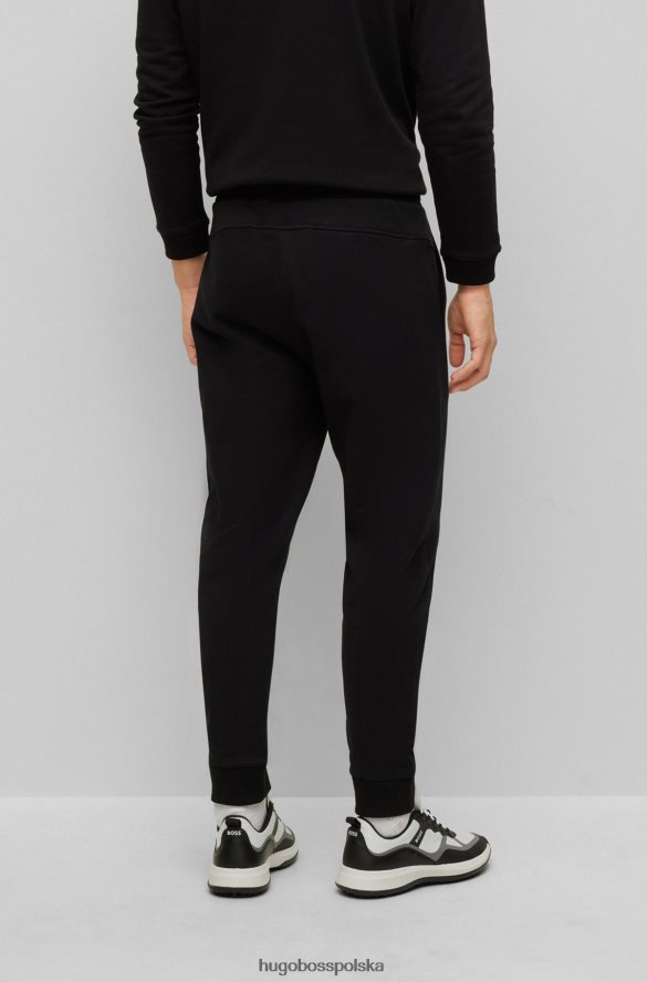 Hugo Boss Spodnie dresowe z bawełny frotte z kontrastowym logo Hugo w kolorze czarnym czarny R0X0H63288