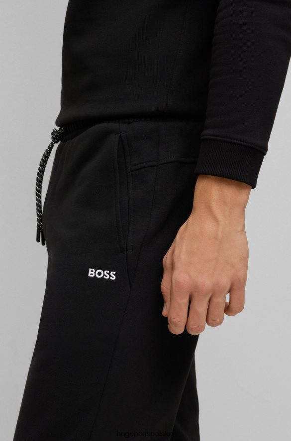 Hugo Boss Spodnie dresowe z bawełny frotte z kontrastowym logo Hugo w kolorze czarnym czarny R0X0H63288