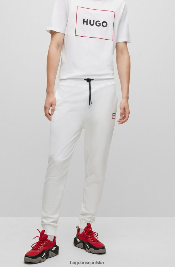 Hugo Boss Spodnie dresowe z bawełny frotte z logo w czerwonej ramce, białe hugo biały R0X0H61069