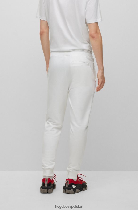 Hugo Boss Spodnie dresowe z bawełny frotte z logo w czerwonej ramce, białe hugo biały R0X0H61069