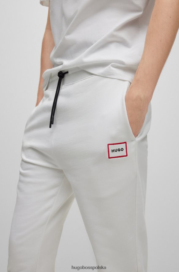 Hugo Boss Spodnie dresowe z bawełny frotte z logo w czerwonej ramce, białe hugo biały R0X0H61069