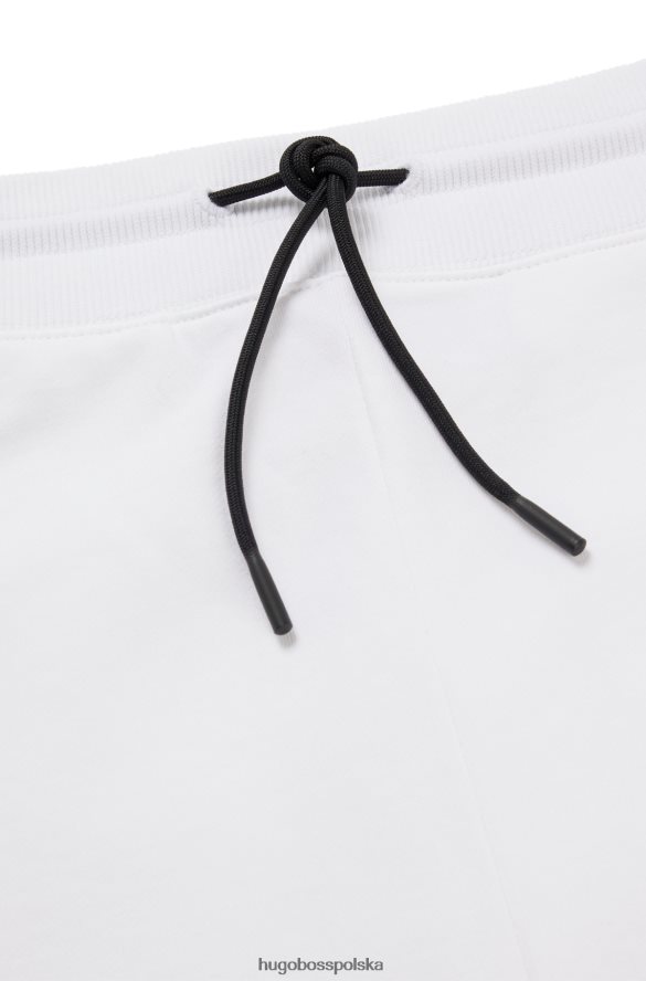 Hugo Boss Spodnie dresowe z bawełny frotte z logo w czerwonej ramce, białe hugo biały R0X0H61069