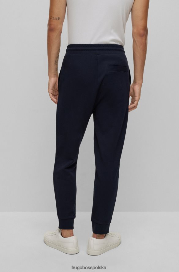Hugo Boss Spodnie dresowe z bawełny frotte z logo w kolorze ciemnoniebieskim hugo ciemny niebieski R0X0H62576