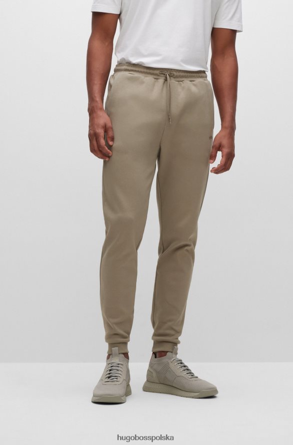Hugo Boss bawełniane spodnie dresowe z zakrzywionym logo hugo w kolorze beżowym beżowy R0X0H62534