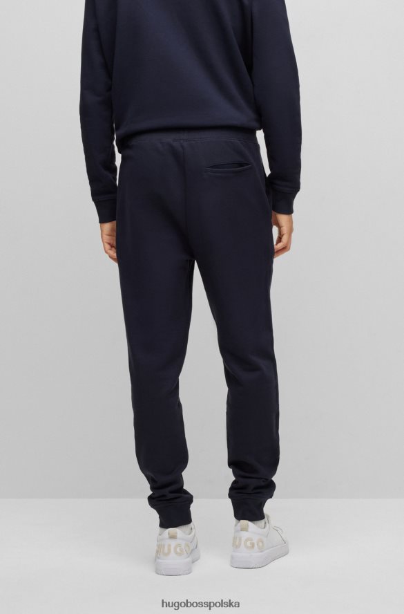 Hugo Boss ciemnoniebieskie spodnie dresowe z bawełny frotte z detalami z logo hugo ciemny niebieski R0X0H63349