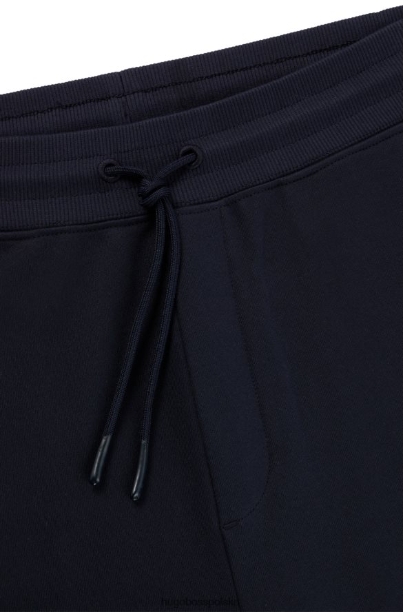 Hugo Boss ciemnoniebieskie spodnie dresowe z bawełny frotte z detalami z logo hugo ciemny niebieski R0X0H63349