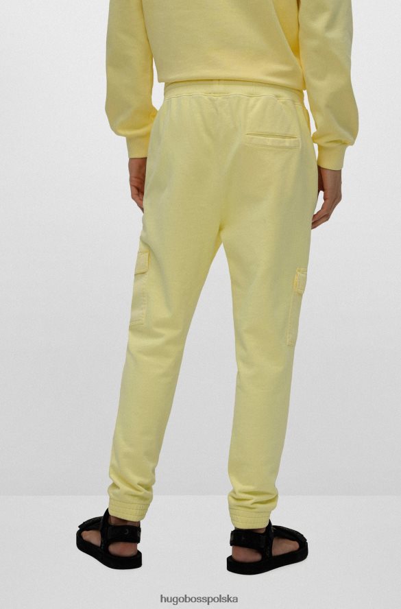 Hugo Boss jasnożółte spodnie dresowe Hugo z bawełny frotte i czerwoną metką z logo jasny zółty R0X0H64330