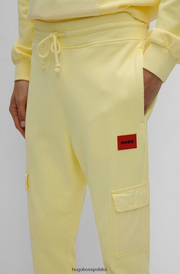 Hugo Boss jasnożółte spodnie dresowe Hugo z bawełny frotte i czerwoną metką z logo jasny zółty R0X0H64330