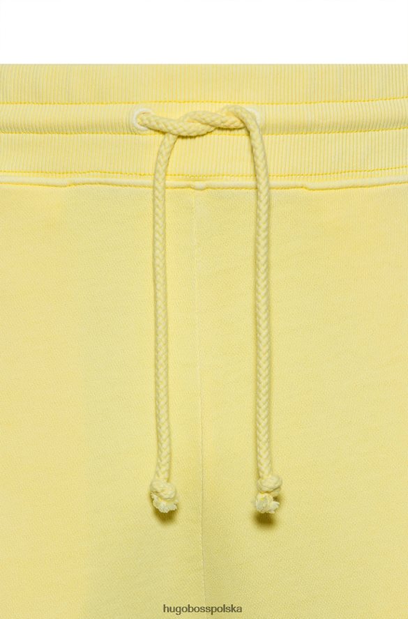 Hugo Boss jasnożółte spodnie dresowe Hugo z bawełny frotte i czerwoną metką z logo jasny zółty R0X0H64330