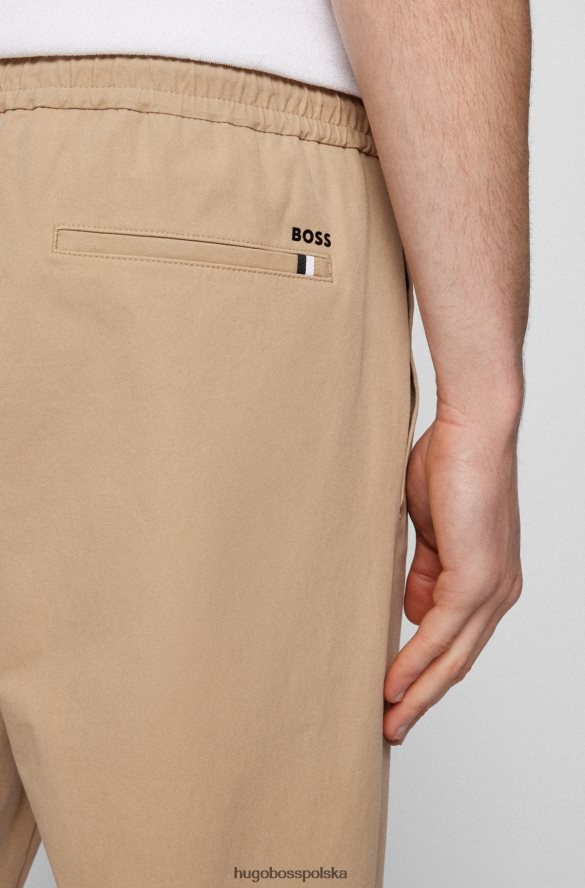 Hugo Boss Jasnobeżowe spodnie dresowe Hugo z domieszką bawełny, z zapinanymi na zamek nogawkami jasny beż R0X0H63402