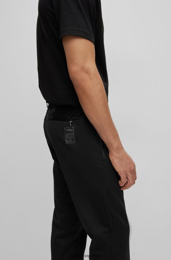 Hugo Boss x ajbxng Wąskie spodnie z regularnym stanem i wspólnym brandingiem czarny R0X0H62728